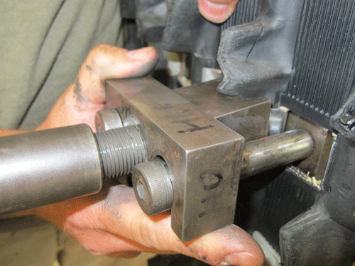 Legs of the track clip installation tool are fed through the window.