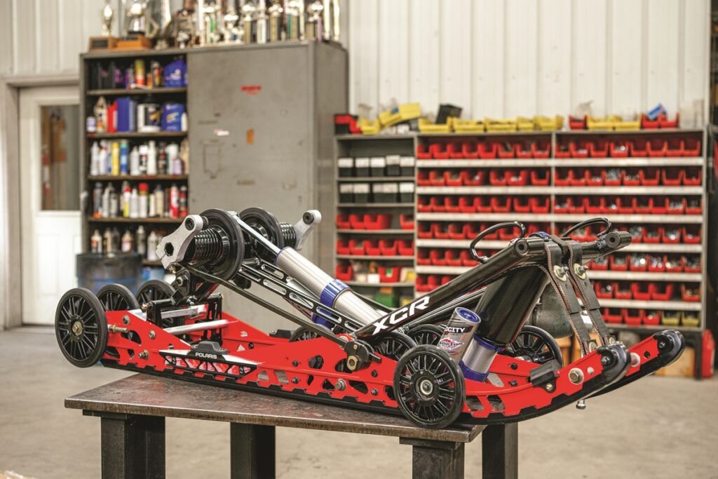 Polaris Indy XCR snowmobile on a rough trail demonstrating long-tail rear suspension performance